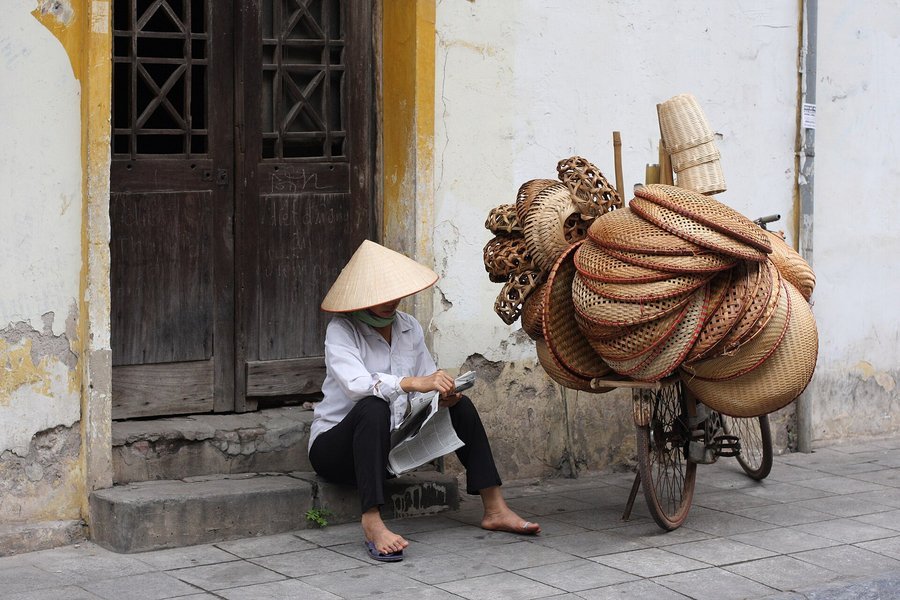 Street vendor with a shoulder pole in the Hanoi Old Quarter