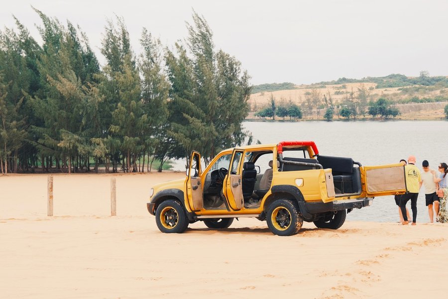 Jeep beside the lake at the White Sand Dunes, Mui Ne