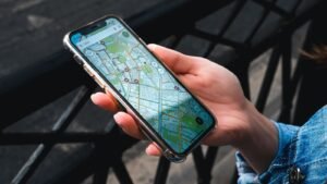A hand holding a smartphone showing a city map